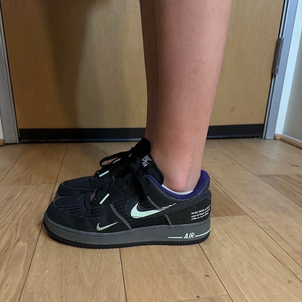 Nike Black and Purple Glow in the dark black AF1s Sneakers.